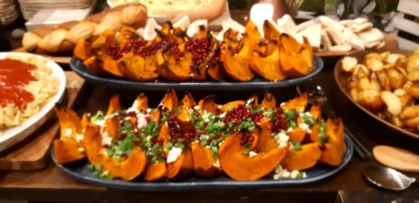 Trays of slow-roasted caramelised pumpkin and roast vegetables